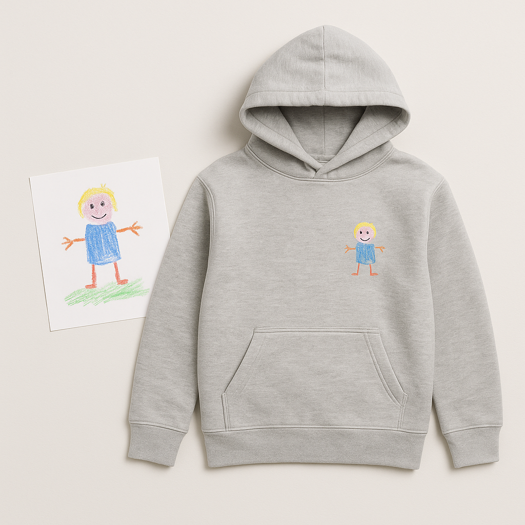 Grey hoodie with a child's crayon drawing printed on the chest, next to the original drawing